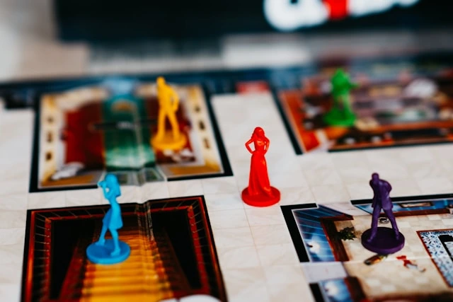 Colorful game figures across a board representing competitive analysis and market positioning