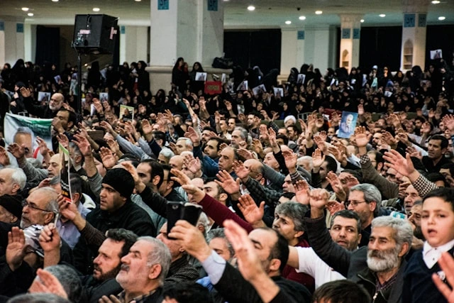 Unsplash, Large crowd raising hands, symbolizing customer feedback and public perception of your brand